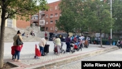 Alrededor de 300 personas acuden a la Plaza San Amaro, en Madrid, para recibir alimentos y productos para los niños. 
