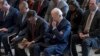 President Joe Biden, with from left, House Minority Leader Hakeem Jeffries and House Speaker Mike Johnson, pray and listen during the National Prayer Breakfast, Feb. 1, 2024, at the Capitol in Washington.