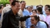 Member of parliament and Cambodia's former prime minister Hun Sen (L) greets commune councilors after he cast his vote at a polling station during the Senate election in Takhmao city, Kandal province on Feb. 25, 2024. 