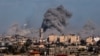 This picture taken from Rafah, in the southern Gaza Strip, shows smoke rising over buildings in Khan Yunis during Israeli bombardment on Feb. 1, 2024.