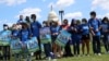 FILE - Demonstrators lock arms during a rally with migrant families and immigration advocates calling for a pathway towards citizenship, on Capitol Hill in Washington, Sept. 20, 2021. 
