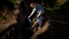 Joan Torrent fills plastic jugs at a natural spring in Gualba, about 50 kilometers, (31 miles) northwest of Barcelona, Spain, Jan. 31, 2024. Almost every day, he into the woods in search of drinking water. 