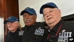 FILE - Members of the Never Miss a Super Bowl Club, from the left, Tom Henschel, Gregory Eaton, and Don Crisman pose for a group photograph during a welcome luncheon, in Atlanta, Feb. 1, 2019. 