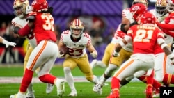 San Francisco 49ers running back Christian McCaffrey (23) runs the ball against the Kansas City Chiefs during the first half of the NFL Super Bowl football game in Las Vegas, Nevada, Feb. 11, 2024.