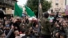 Palestinian gunmen march with bodies of militants, draped in the flags of the Palestinian Islamic Jihad, killed in an Israeli military raid at Ibn Sina Hospital in the West Bank town of Jenin, Jan. 30, 2024.