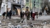 This handout photo taken and released by Ukrainian Emergency Service on Feb. 2, 2024, shows rescuers working outside a building damaged after an air strike on Kherson, Ukraine. (Ukrainian Emergency Service via AFP) 