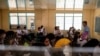Grade 12 students use hand fans as they attend a class at the Commonwealth High School in Quezon City, Metro Manila, Philippines, April 18, 2024. 