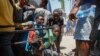 Sejumlah anak muda berlindung setelah mendengar suara tembakan di sebuah sekolah umum yang berfungsi sebagai tempat penampungan bagi orang-orang yang mengungsi akibat kekerasan geng, di Port-au-Prince, Haiti, Jumat, 22 Maret 2024. (Foto: Odelyn Joseph/AP Photo)