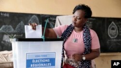 A voter casts her ballot in Togo's regional elections in the capital, Lome, April 29, 2024. 