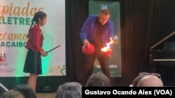 El "Mago León" prende fuego a un recipiente donde segundos luego reaparecería un globo con forma de perro que había estallado con el pie, en Maracaibo, Venezuela.