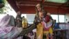 A handout photograph shot in January 2024 shows a woman and baby at the Zamzam displacement camp, close to El Fasher in North Darfur, Sudan. (MSF/Mohamed Zakaria/Handout)