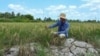 FILE - A farmer looks at his crop in a dry rice field in southern Vietnam's Ca Mau province, Feb. 23, 2024.