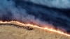 Petugas damkar menggunakan buldoser untuk memadamkan kebakaran Corral dekat Tracy, California, Minggu, 2 Juni 2024. (Departemen Kehutanan dan Perlindungan Kebakaran California via AP)