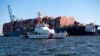 This image provided by the U.S. Coast Guard shows the U.S. Coast Guard Cutter Sailfish, as it prepares to escort the cargo ship Dali during its transit from the Port of Baltimore to the Port of Virginia, Monday, June 24, 2024.