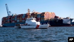 This image provided by the U.S. Coast Guard shows the U.S. Coast Guard Cutter Sailfish, as it prepares to escort the cargo ship Dali during its transit from the Port of Baltimore to the Port of Virginia, Monday, June 24, 2024.
