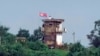FILE - Seorang tentara Korea Utara berdiri di pos jaga militer Korea Utara saat bendera Korea Utara berkibar tertiup angin, terlihat dari Paju, Korea Selatan, 24 Juli 2024.