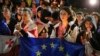 Demonstrators with Georgian and EU flags and candles stand in front of the Kashveti Church of St. George during an opposition protest against a draft "foreign agents" bill in the center of Tbilisi, Georgia, May 3, 2024.