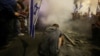 A demonstrator sits during a protest in Tel Aviv, Israel, against Israeli Prime Minister Benjamin Netanyahu's government and call for the release of hostages kidnapped in Hamas' deadly October 7 attack on Israel, March 30, 2024