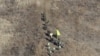 FILE - North Korean army soldiers, top, head to cross the Military Demarcation Line inside the Demilitarized Zone (DMZ) to inspect the dismantled South Korean guard post, Dec. 12, 2018.