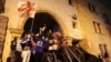 Protesters barricade the entrance of Georgia's Parliament in Tbilisi, Georgia, during a rally to protest a bill on "foreign agents," May 2, 2024.