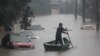 A man rows a boat on a street flooded by heavy rains, in Sao Leopoldo, Rio Grande do Sul state, Brazil, May 11, 2024. 