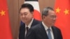 South Korean President Yoon Suk Yeol and Chinese Premier Li Qiang move their positions during a meeting at the Presidential Office in Seoul, South Korea, May 26, 2024.