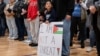 FILE - Mourners attend a vigil for Wadea Al-Fayoume, 6, a Muslim boy who police say was stabbed to death in an attack that targeted him and his mother for their religion and the Israel-Gaza war, in Plainfield, Illinois, Oct. 17, 2023.
