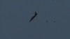 FILE - A warplane carries out a bombing run above Syria near the Israeli-Syrian border as it is seen from the Israeli-occupied Golan Heights, Israel July 24, 2018.