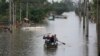 Residents paddle across a flooded area after heavy rain in Canoas, Rio Grande do Sul state, Brazil, May 10, 2024.