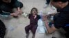 FILE - Palestinian medics treat a wounded baby at Al Aqsa Hospital in Deir al-Balah, Gaza Strip, May 11, 2024. U.S. officials are working to get upward of 20 American doctors and medical workers who The Intercept reports are trapped in Gaza.  