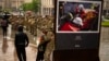 An army comrade is comforted as he cries during the funeral ceremony of Ukrainian army paramedic Nazarii Lavrovskyi, 31, killed in the war, at Independence square in Kyiv, April 24, 2024.