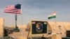 FILE - US and Niger flags are raised at the base camp for air forces and other personnel supporting the construction of Niger Air Base 201 in Agadez, Niger, April 16, 2018. 