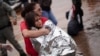 A firefighter carries a girl rescued from an area flooded by heavy rains in Porto Alegre, Rio Grande do Sul state, Brazil, May 4, 2024. 