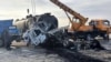 This handout photo released by Afghanistan's Helmand Information Department shows the wreckage of a passenger bus and oil tanker after the bus collided with a motorbike, then crashed into the tanker in Helmand province, killing 21 people, on March 17, 2024.