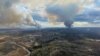 This handout image released by Alberta Wildfire shows smoke columns going in multiple directions due to shifting winds in Fort McMurray Forest Area, Alberta, Canada, on May 13, 2024. 