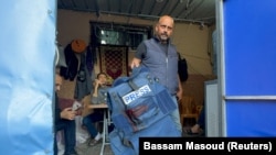 ARCHIVO - Un hombre sostiene el chaleco antibalas del periodista de Al Jazeera Wael Al-Dahdouh, herido en medio del conflicto entre Israel y Hamás, en Khan Younis, sur de la Franja de Gaza, el 15 de diciembre de 2023.