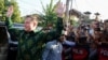 Elon Musk, chief executive officer of SpaceX and Tesla, reacts to the media as he arrives to launch SpaceX's Starlink internet service in Indonesia at a sub district community health center in Denpasar, Bali, May 19, 2024. 