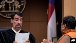 La secretaria del condado de Clerk Ché Alexander , a la derecha, habla con el juez del Tribunal Superior del condado de Fulton, Robert McBurney, en Atlanta, EEUU, el 14 de agosto de 2023.