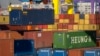 FILE - A crane lifts a shipping container at an automated port in Tianjin, China, Jan. 16, 2023.