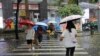 Pedestrians cross a street during a rainstorm in Shenzhen, Guangdong province, China, April 21, 2024 (cnsphoto via Reuters)