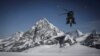 FILE - A helicopter of the Swiss Air Force flies above the Tete Blanche high altitude pass in the Swiss Alps, April 14, 2022. A major search operation is currently underway in the Swiss Alps to find six ski hikers missing since March 9, 2024.