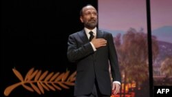 FILE - Iranian film director and member of the Jury of the Official Selection Asghar Farhadi arrives on stage during the Closing Ceremony of the 75th edition of the Cannes Film Festival in Cannes, southern France, May 28, 2022.