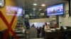 People follow news of a crash of a helicopter that was carrying Iran's President Ebrahim Raisi amd other officials, on a TV in a shop in Tehran, Iran, May 19, 2024. 