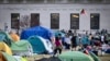 A student protester flies a kite inside the protest encampment on the Columbia University campus, April 29, 2024, in New York. Columbia University on Monday began suspending pro-Palestinian activists who refused to dismantle a tent encampment on its New York City campus