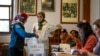 A woman votes at a polling station in Istanbul, March 31, 2024.