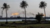 FILE - Flare stacks burn at the Nihran Bin Omar oil field, north of Basra, Iraq, March 22, 2023.