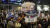 Protesters carry placards during a gathering called for by relatives of Israeli hostages held in Gaza since the October 7 attacks by Hamas militants, in Tel Aviv on March 9, 2024.