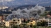 Smoke billows above buildings following an Israeli strike in the southern Lebanese border village of Majdal Zoun on March 9, 2024.
