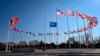 FILE - An empty mast is seen among NATO member nation flags at alliance headquarters in Brussels, Feb. 27, 2024, ahead of a flag-raising ceremony for Sweden’s accession to NATO, approved by lone hold-out Hungary March 5, 2024.