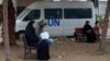Displaced Palestinian people sit on benches as they wait outside a clinic of the United Nations Relief and Works Agency for Palestine Refugees in Rafah in the southern Gaza Strip on Jan. 28, 2024.